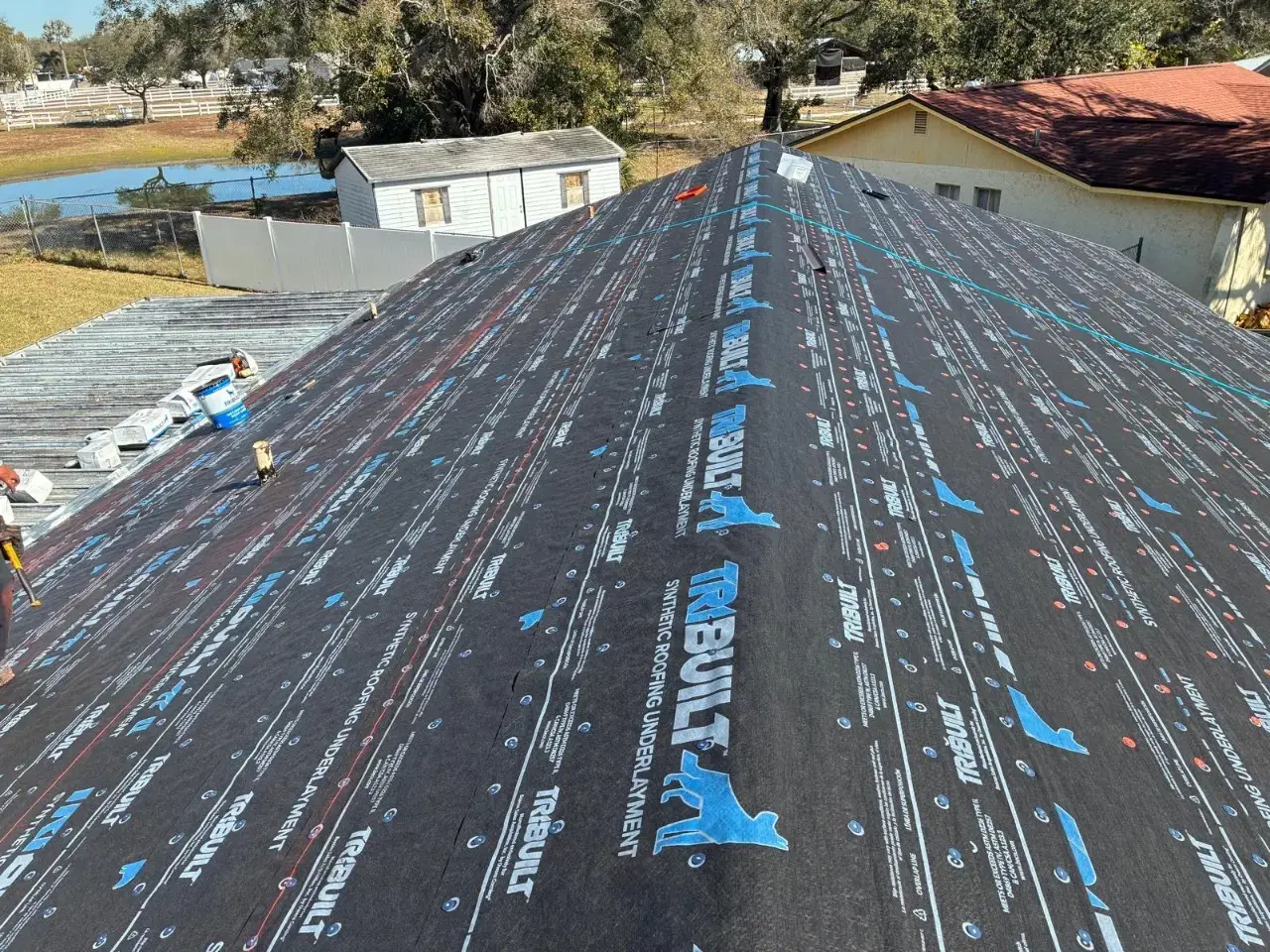 Contact Us Today Synthetic roofing underlayment installed across a residential roof during roof replacement
